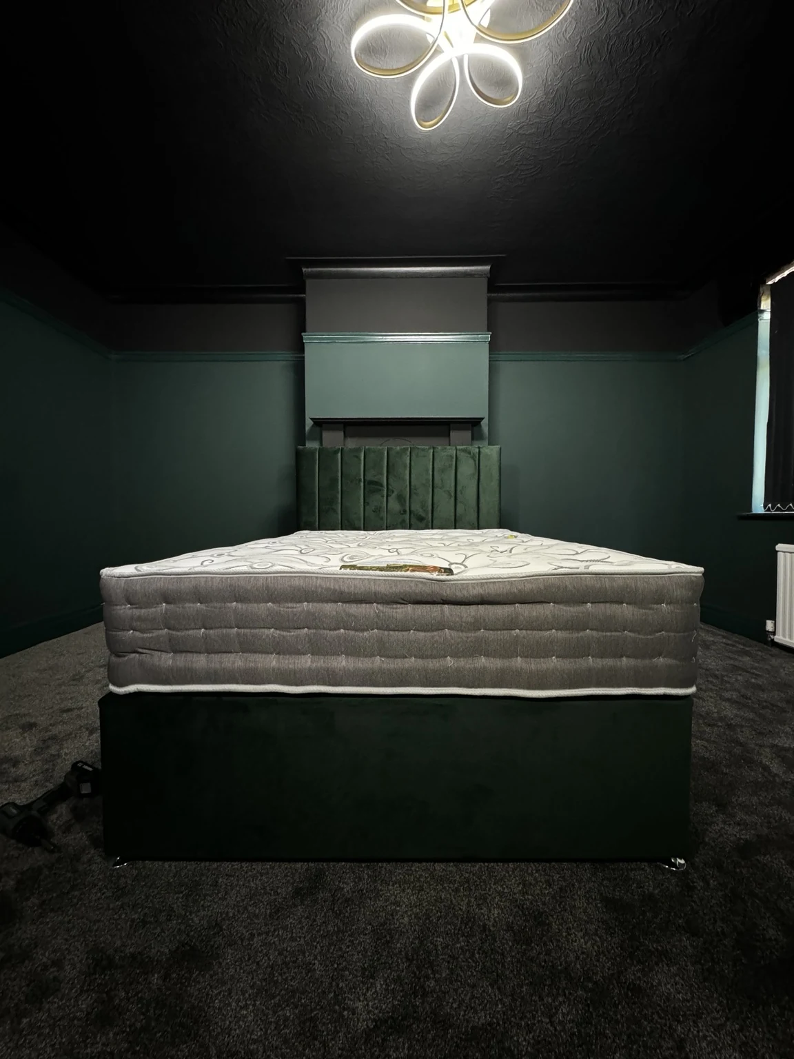 Bedroom after transformation with dark green walls and black ceiling